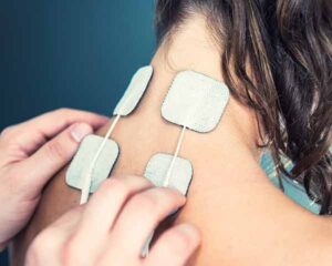 TENS Units being placed on a persons neck. Shoreside Interventional Pain, Sarasota, Florida.