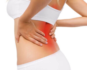 Person holding back in pain with red overlay denoting lower back area. Shoreside Interventional Pain in Sarasota, FL