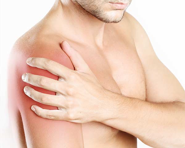 Man holding shoulder to show muscle pain. Shoreside Pain in Sarasota, Florida